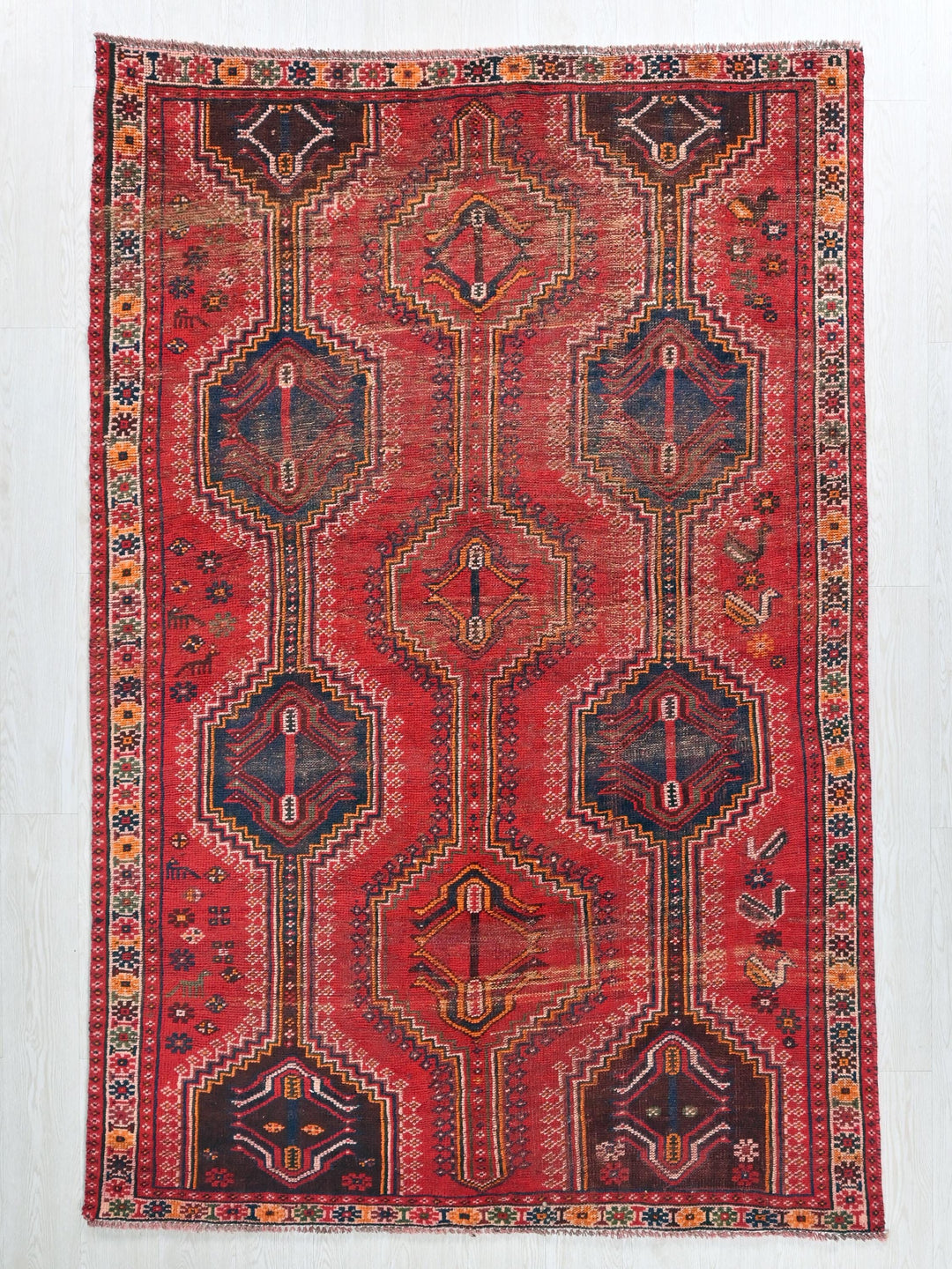 a red rug with a design on it