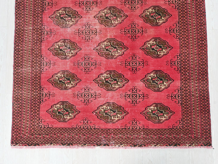 a red rug with a design on it