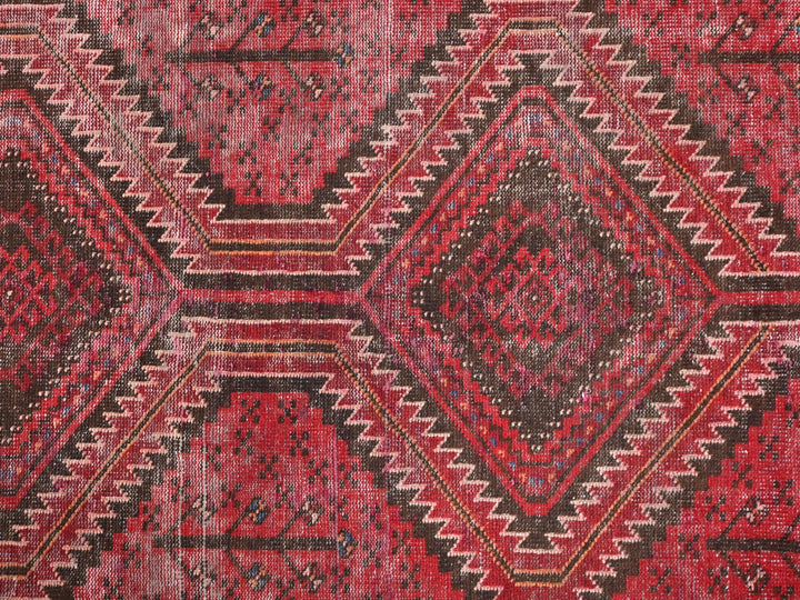 a red rug with a diamond pattern on it