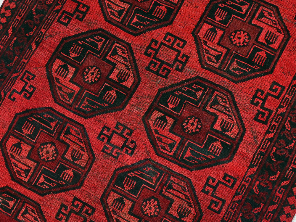 a close up of a red and black oriental rug