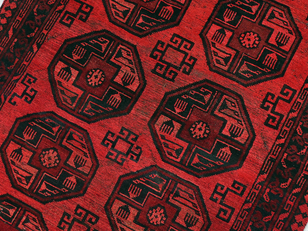 a close up of a red and black oriental rug