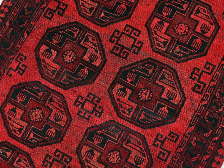 a close up of a red and black oriental rug