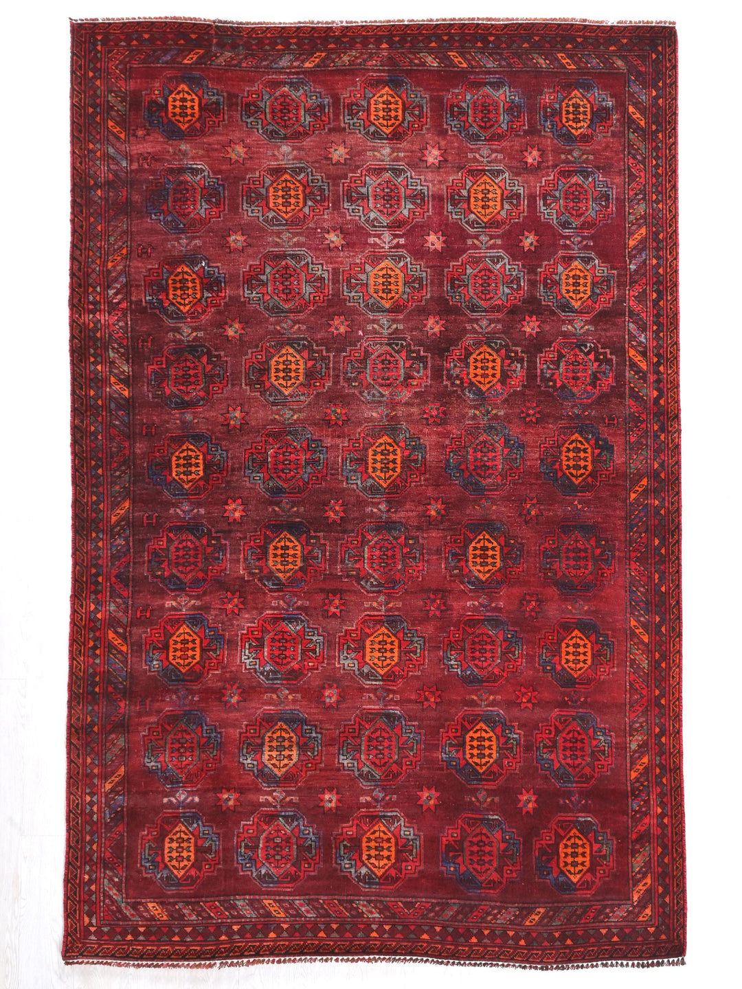 a red rug with a design on the middle of it