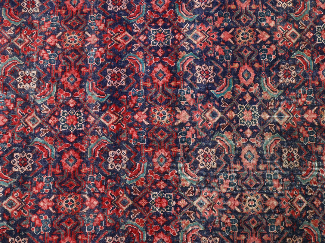 a red, blue, and pink rug with a pattern on it