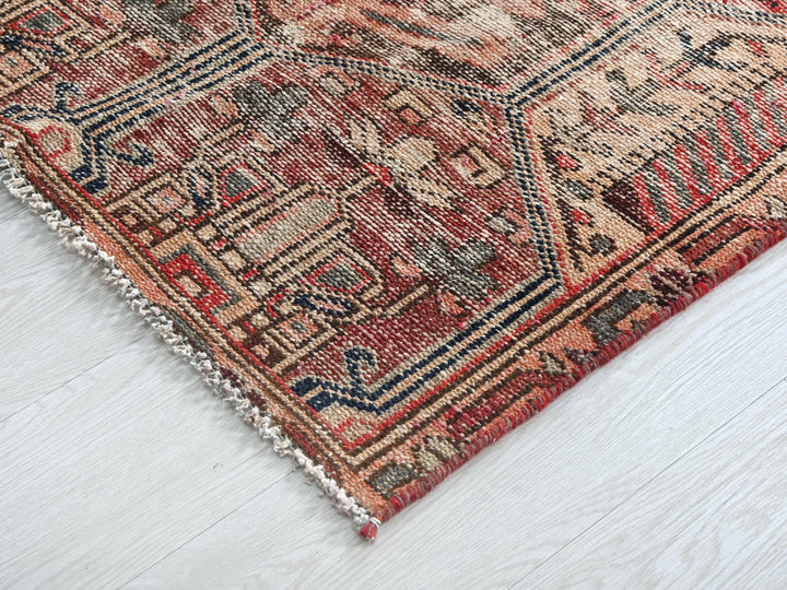 a red and blue rug on a white floor