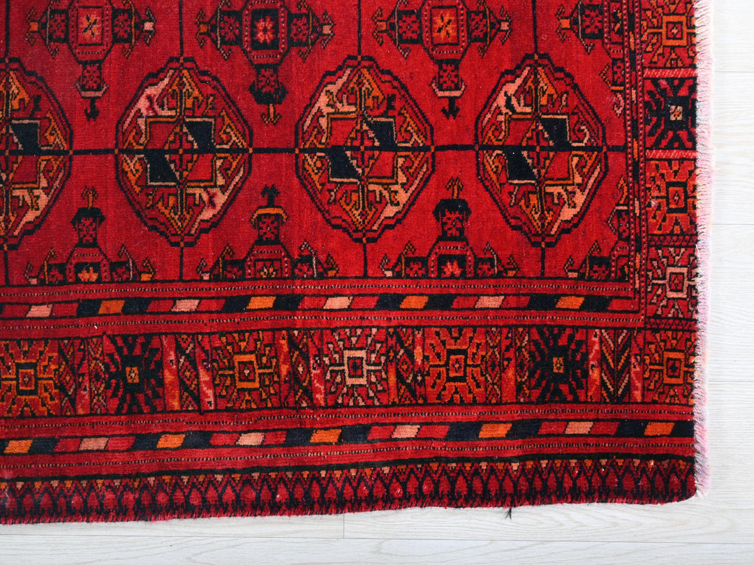 a red rug with a design on it