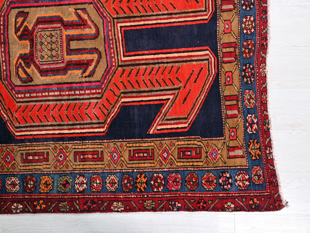 a red and blue rug on a white floor