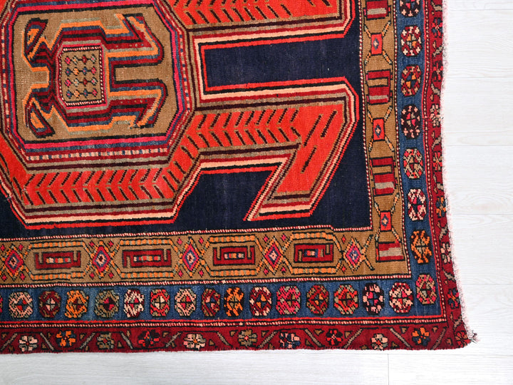 a red and blue rug on a white floor