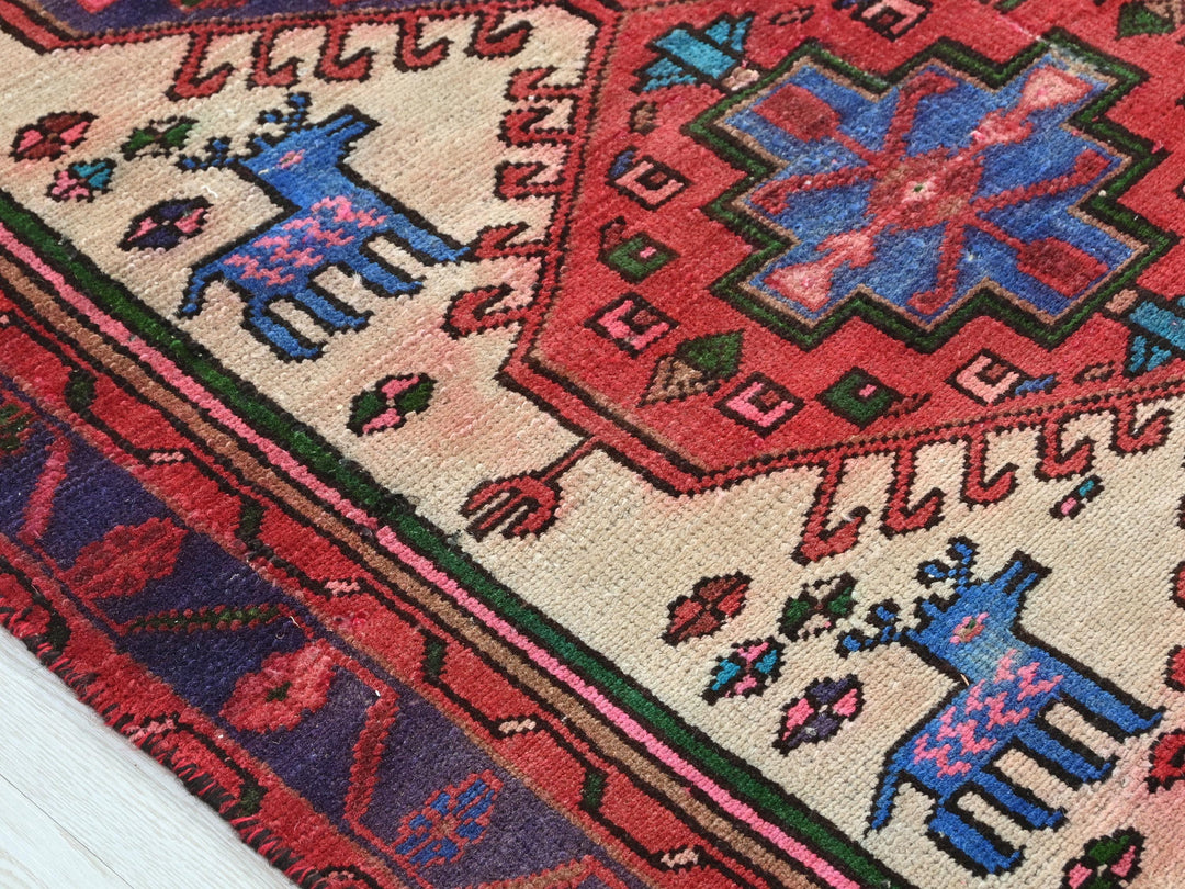 a red rug with a blue and pink design on it