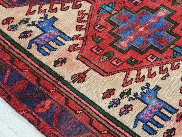 a red rug with a blue and pink design on it