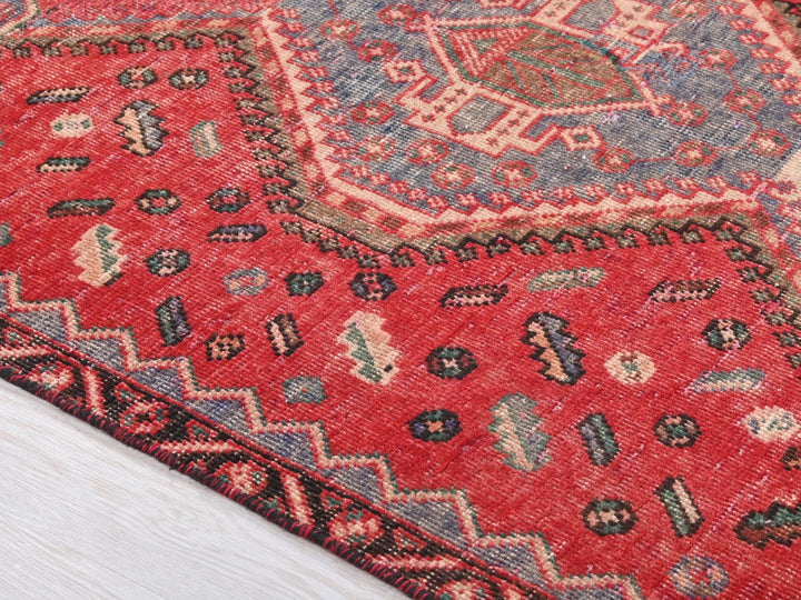 a close up of a rug on a wooden floor