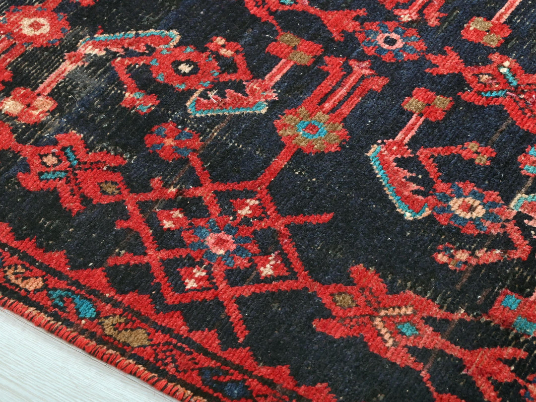 a blue and red rug with a red border