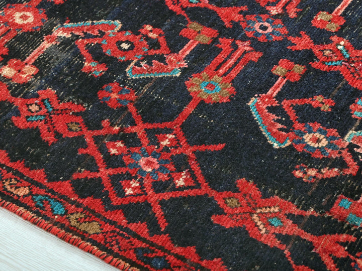 a blue and red rug with a red border