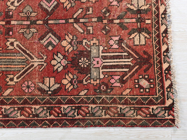 a red rug with a design on it