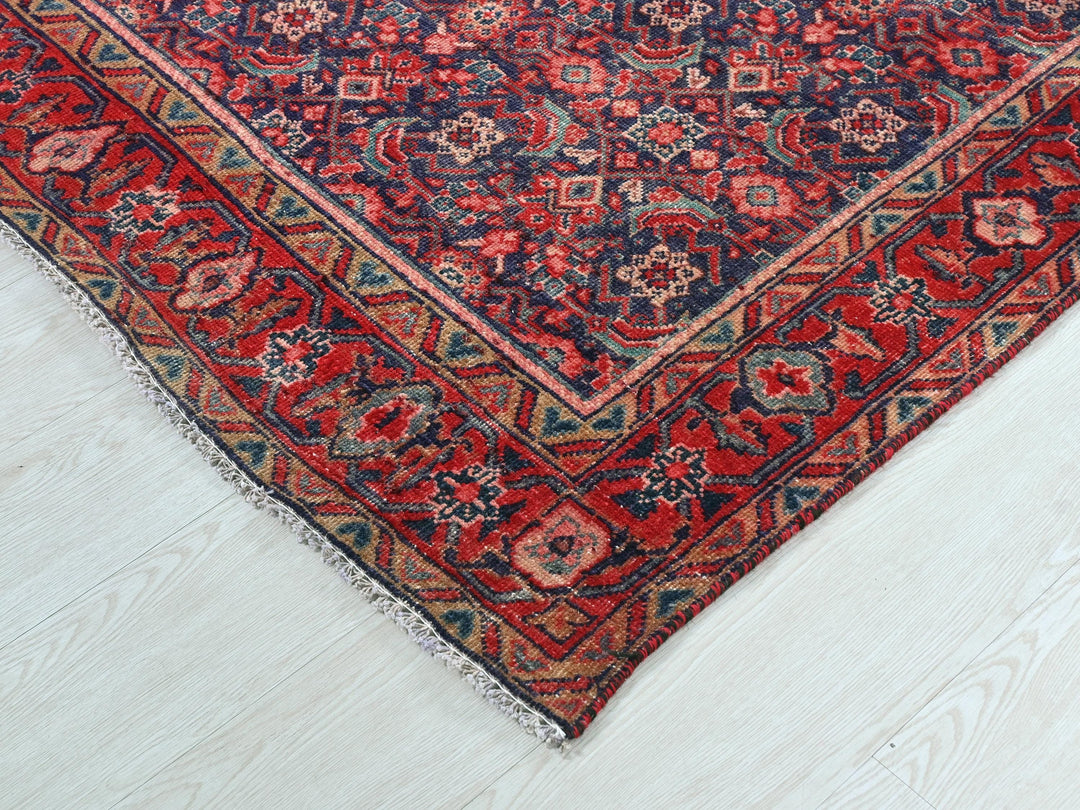 a red and blue oriental rug on a white floor