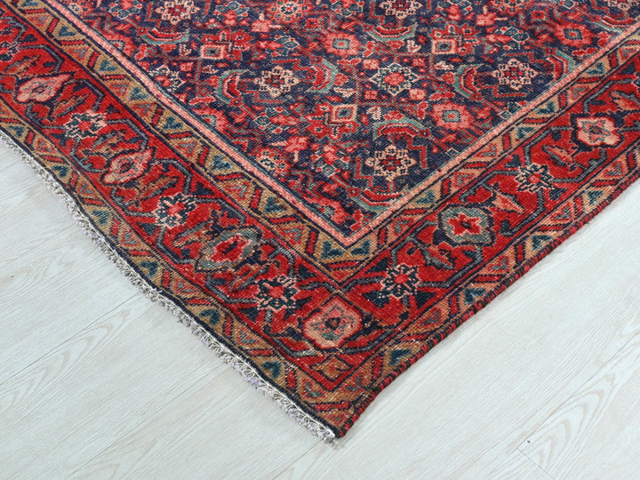 a red and blue oriental rug on a white floor