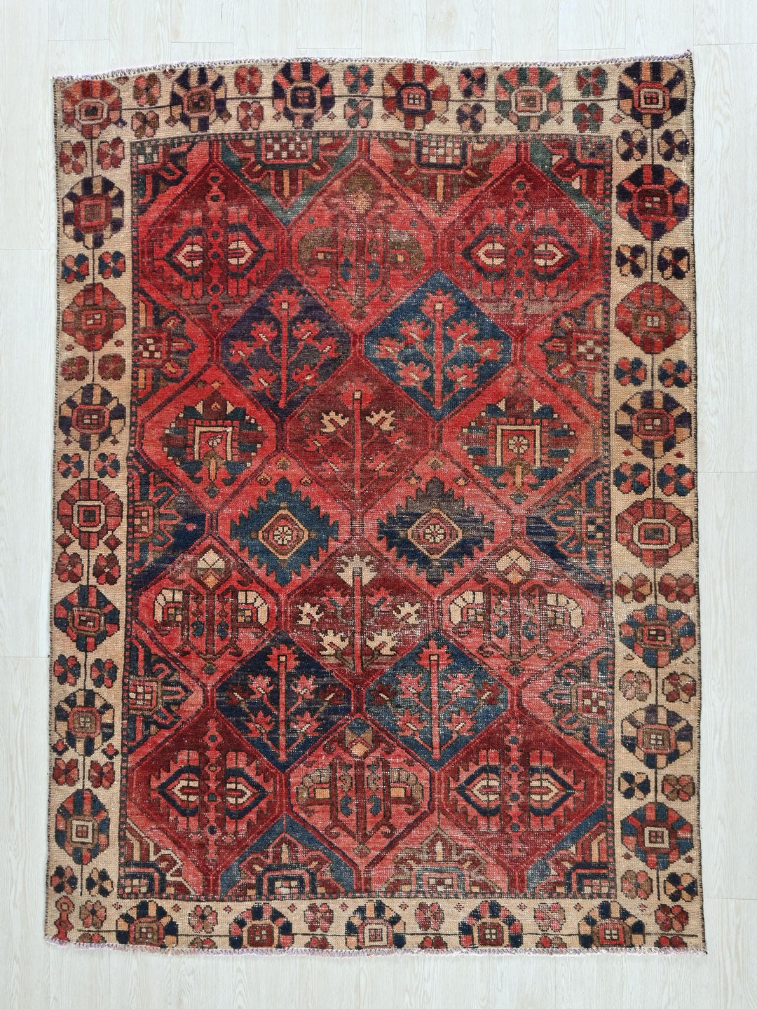 a red and blue rug with a diamond pattern