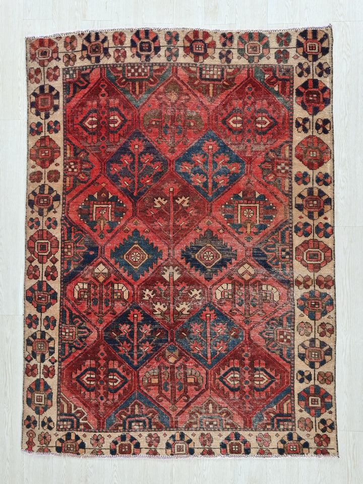 a red and blue rug with a diamond pattern