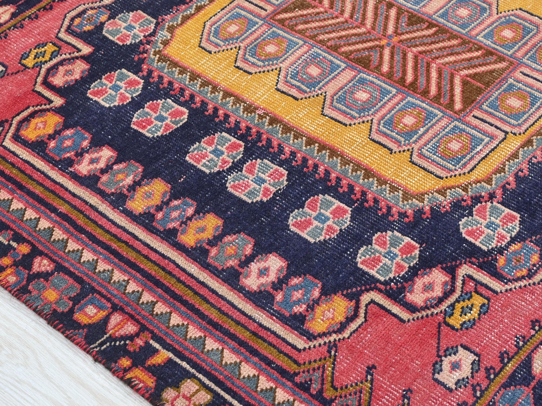 a close up of a colorful rug on a wooden floor