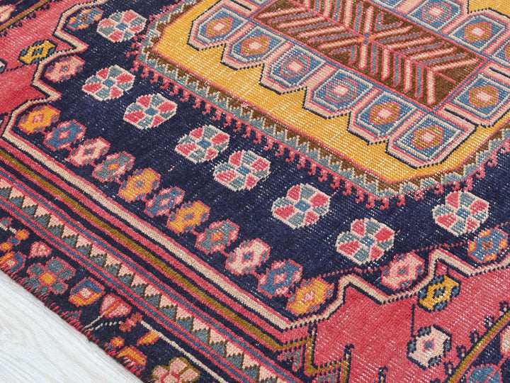 a close up of a colorful rug on a wooden floor