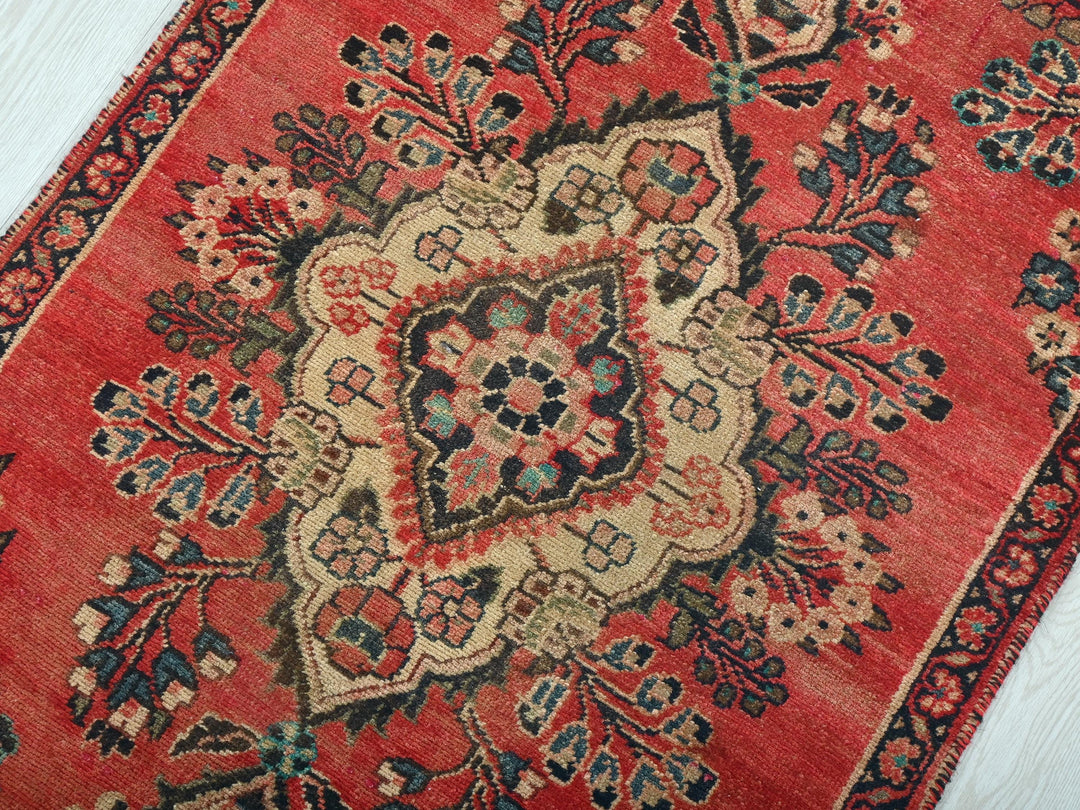 a red rug on a white wooden floor