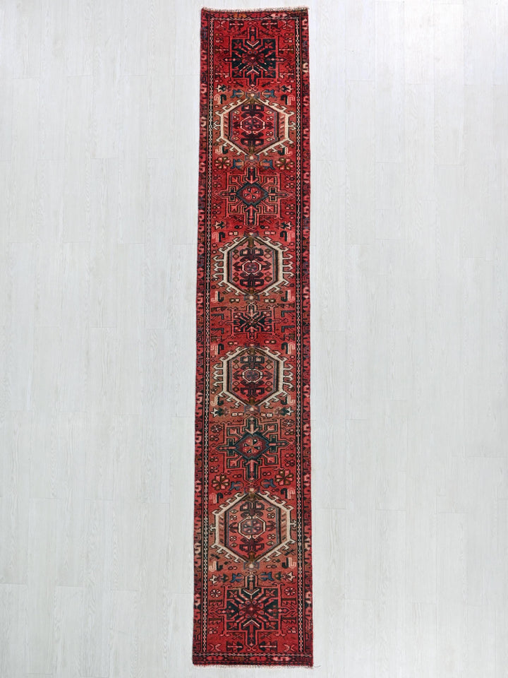 a red runner rug hanging on a wall
