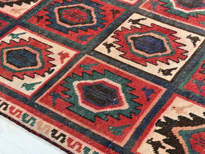 a red and blue rug with a pattern on it