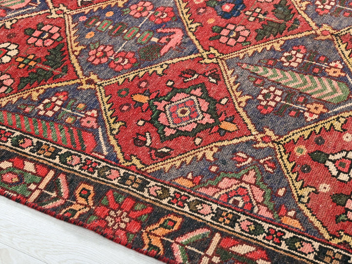 a red rug with a diamond pattern on top of it