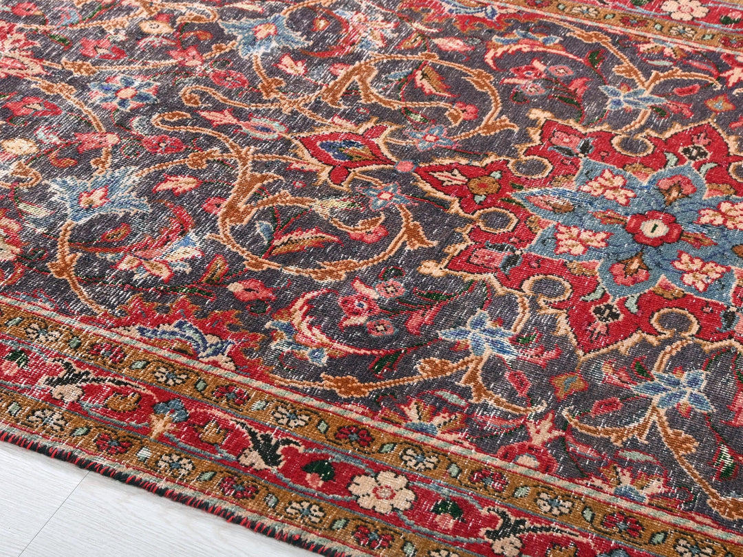 a red and blue oriental rug on a white floor