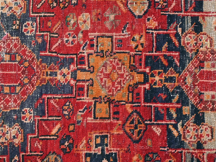 a red and blue rug with a pattern on it