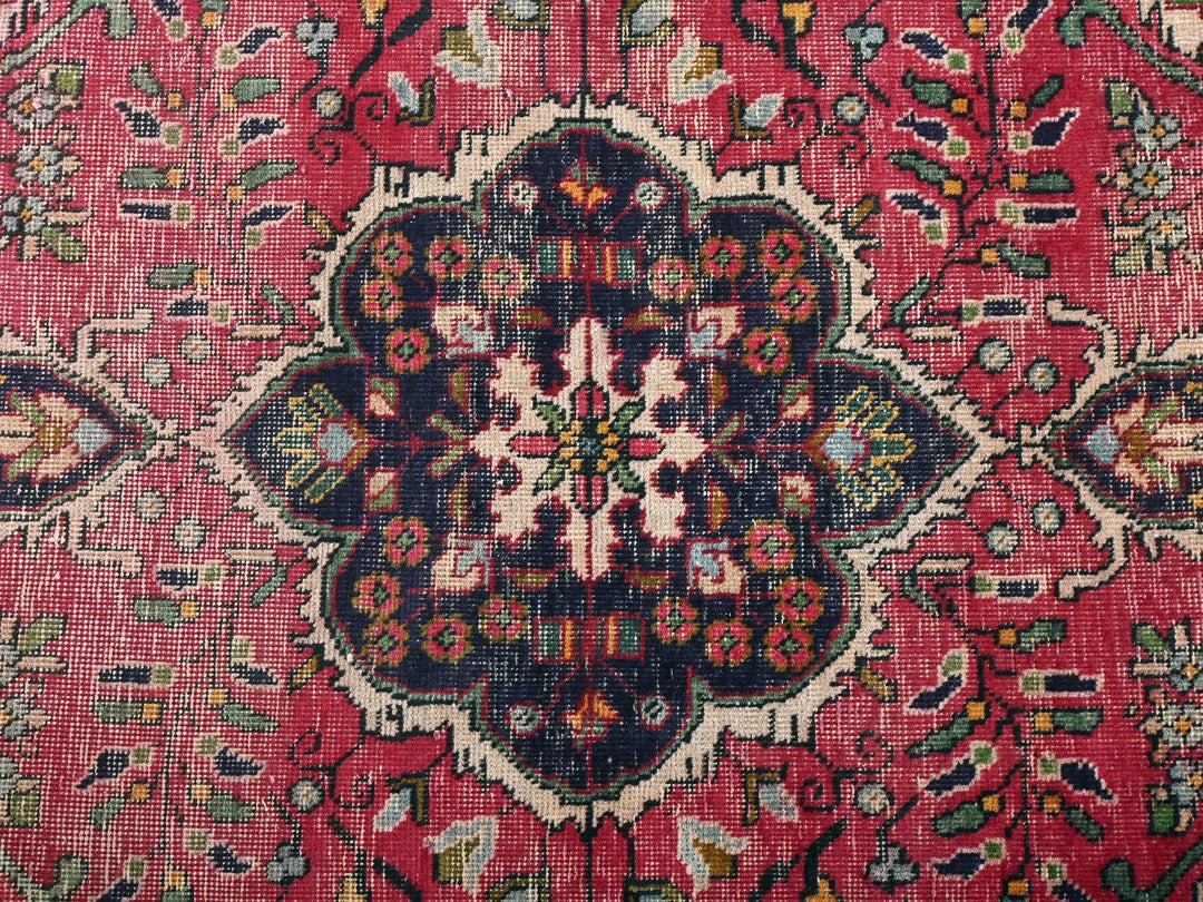 a close up of a rug with a flower design on it