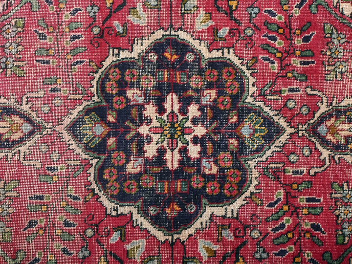 a close up of a rug with a flower design on it