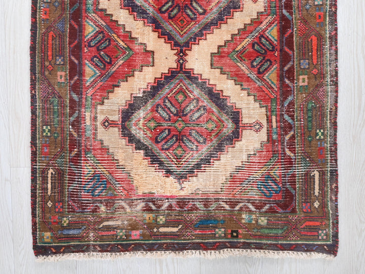 a red and blue rug on a wooden floor