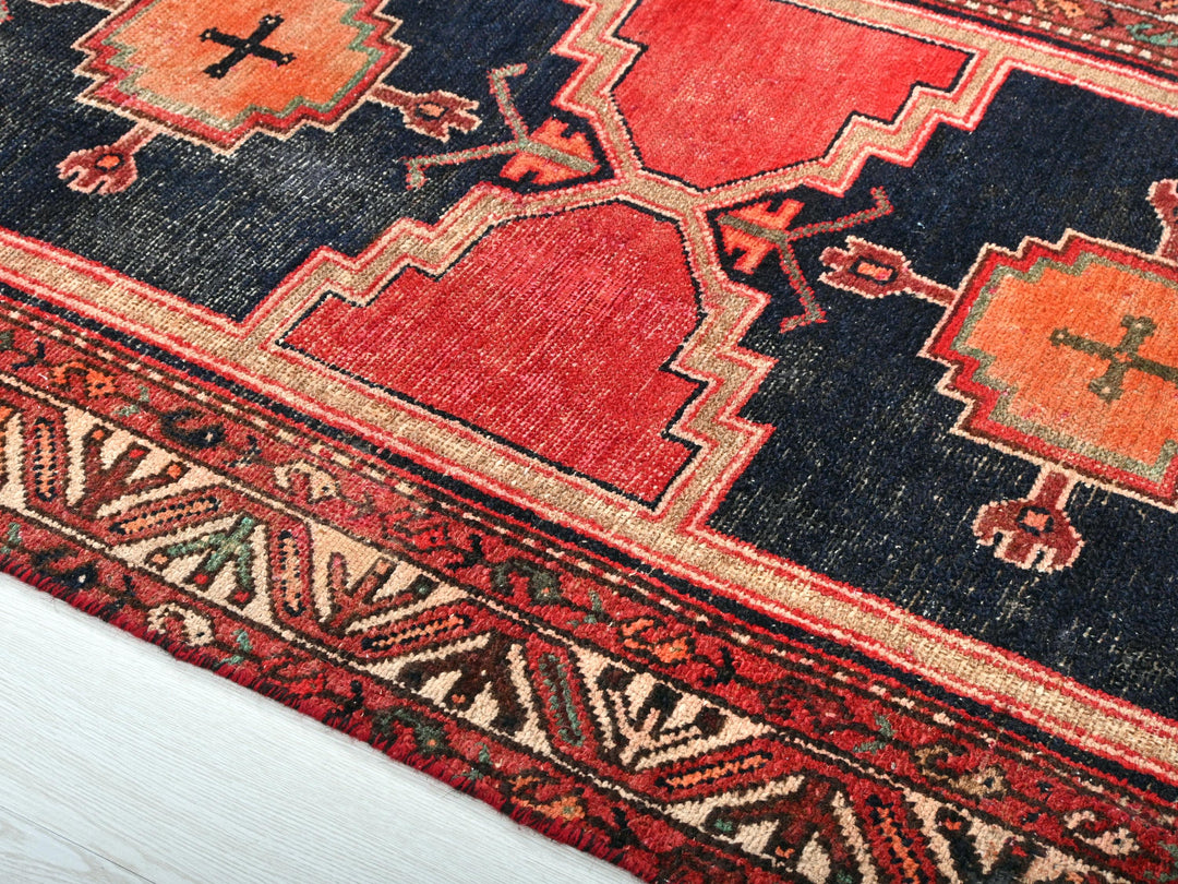 a close up of a rug with a cross on it