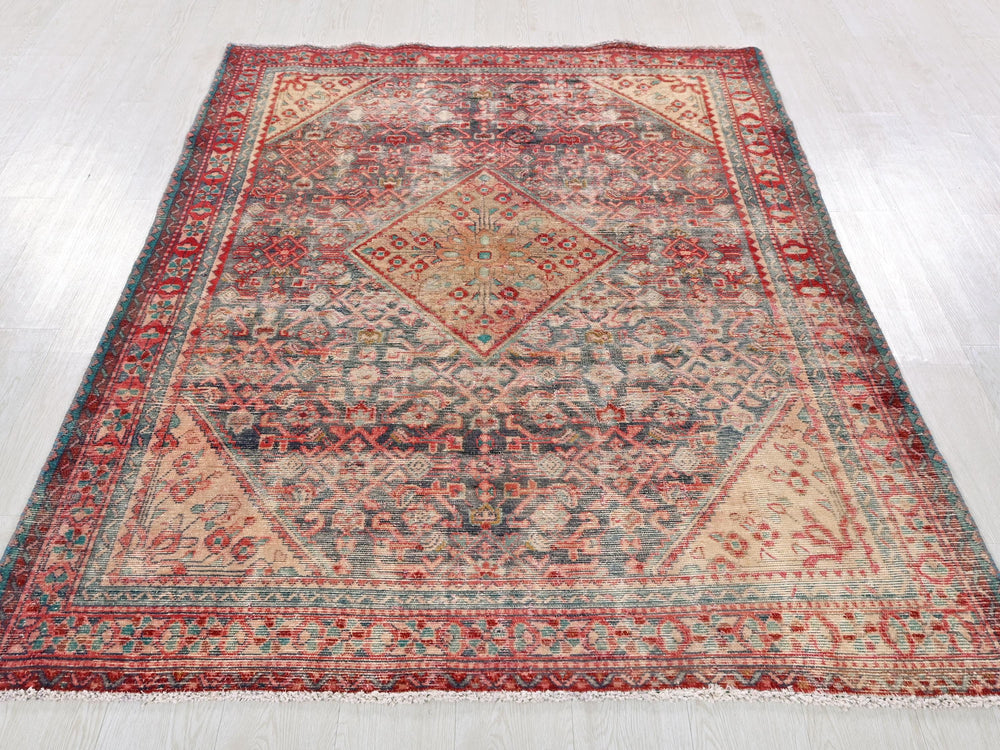 a red and blue rug on a white floor
