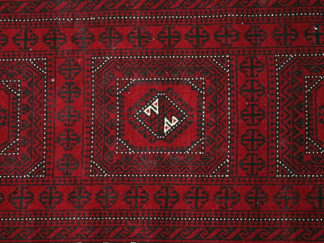 a close up of a red and black rug