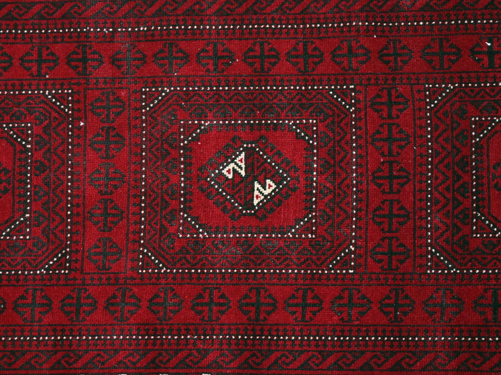 a close up of a red and black rug
