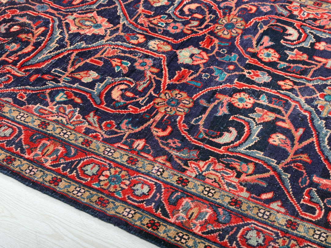 a blue rug with a red and blue design on it