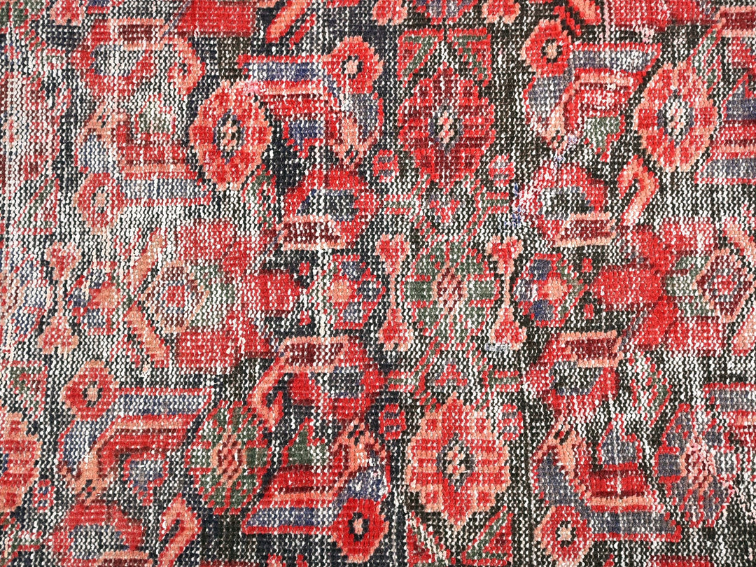 a close up of a red and black rug