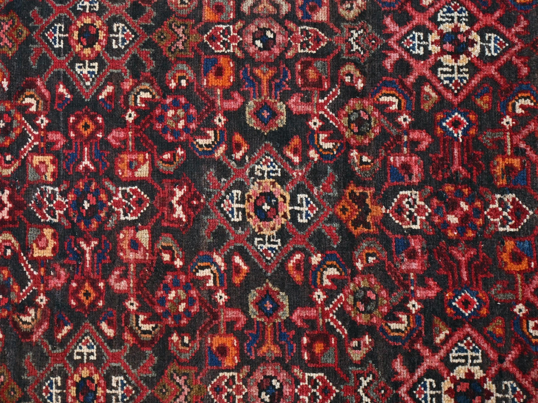 a red, black, and blue rug with a design on it
