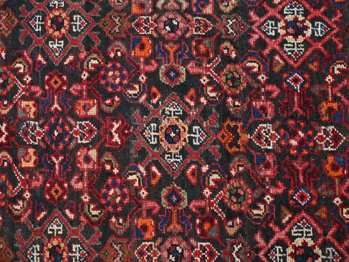 a red, black, and blue rug with a design on it