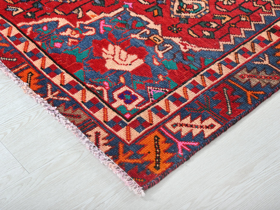 a colorful oriental rug on a white wooden floor