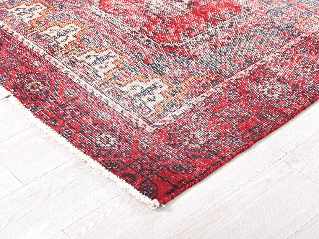 a red and blue rug on a white floor