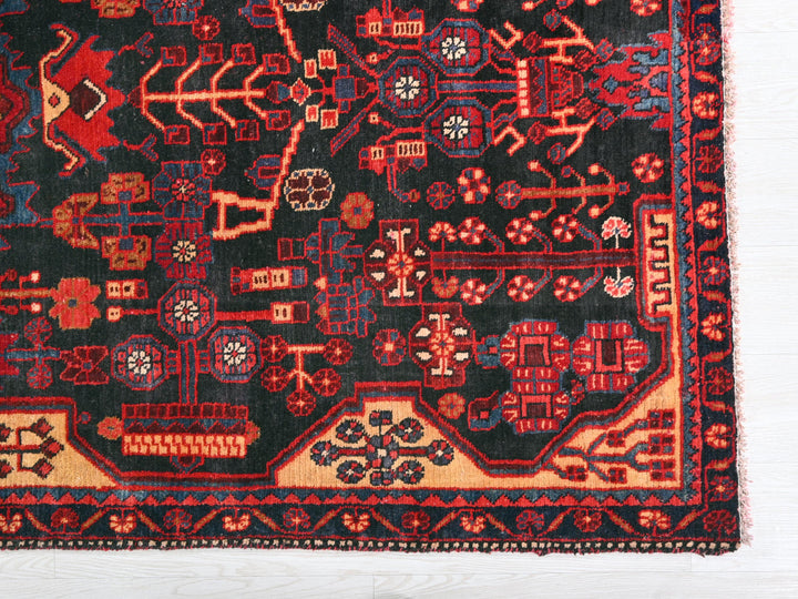 a red and black oriental rug on a white background