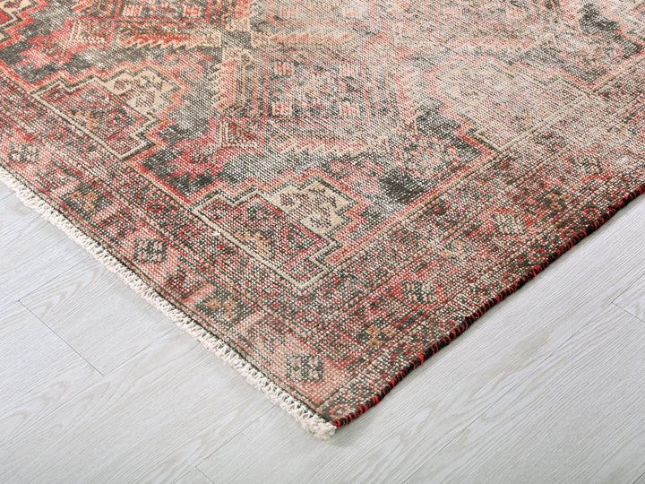 a red and black rug on a white floor