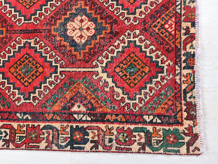 a red and blue rug with a pattern on it