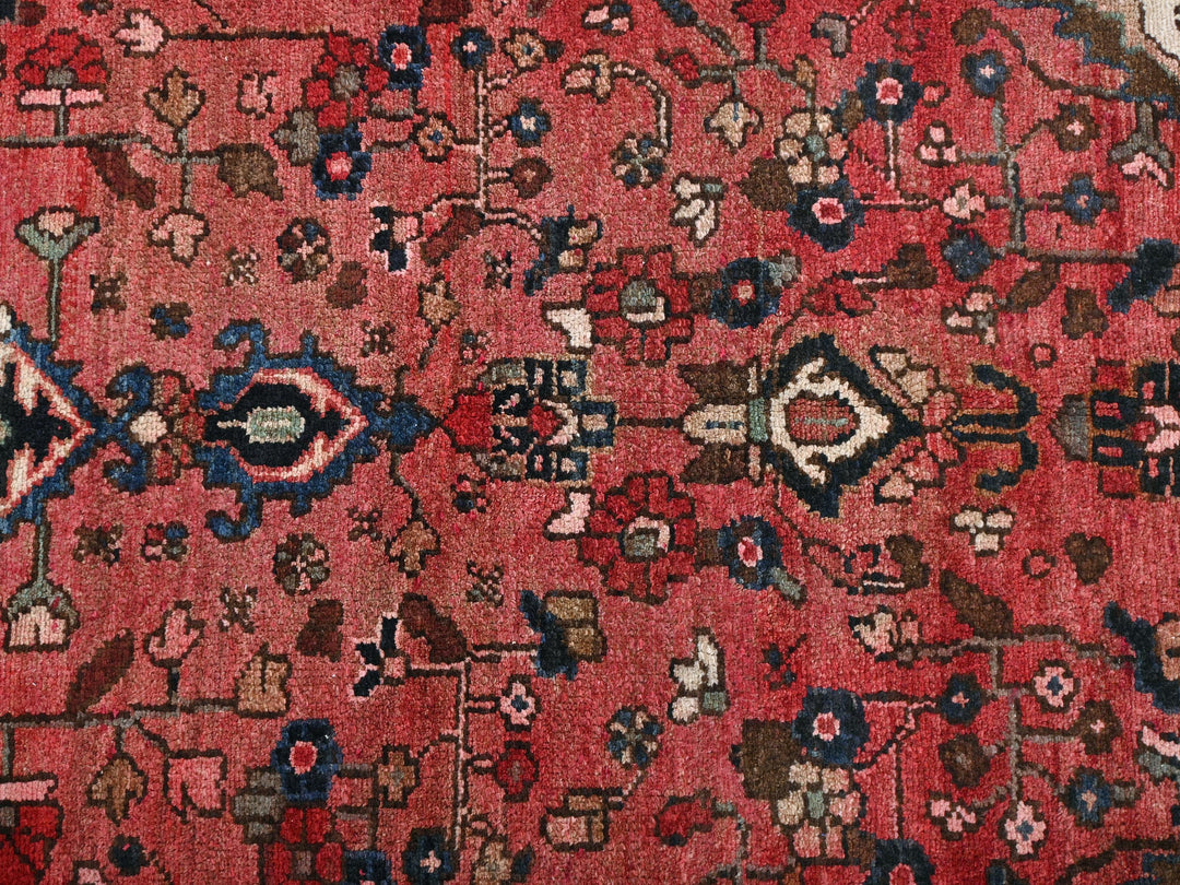 a red rug with many different designs on it