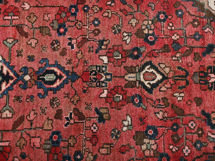 a red rug with many different designs on it