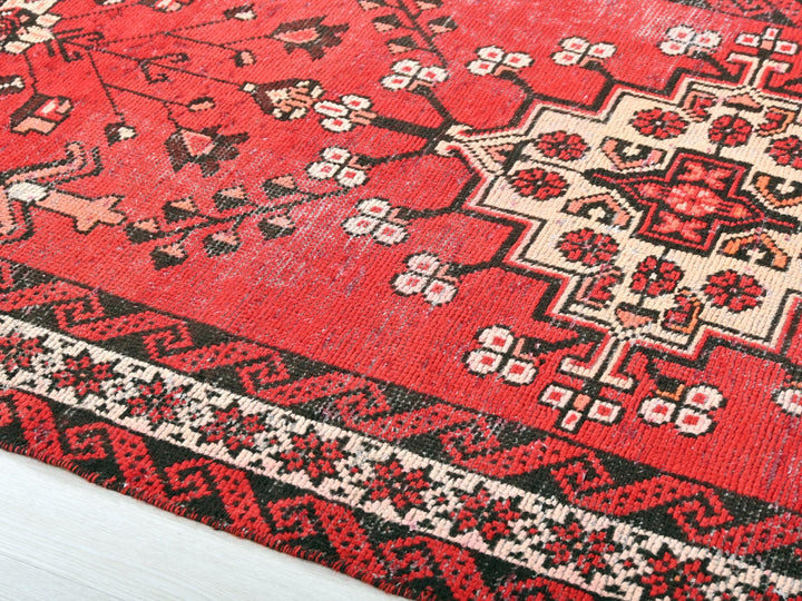 a red rug with black and white designs on it