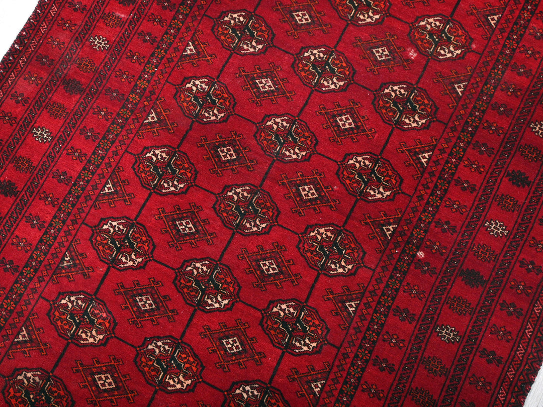 a red rug with a design on it